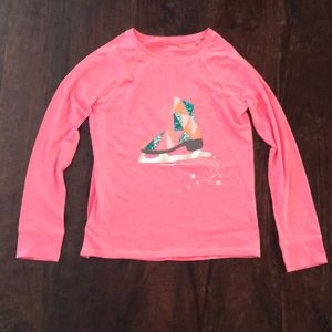 A tweens pink long sleeve shirt.